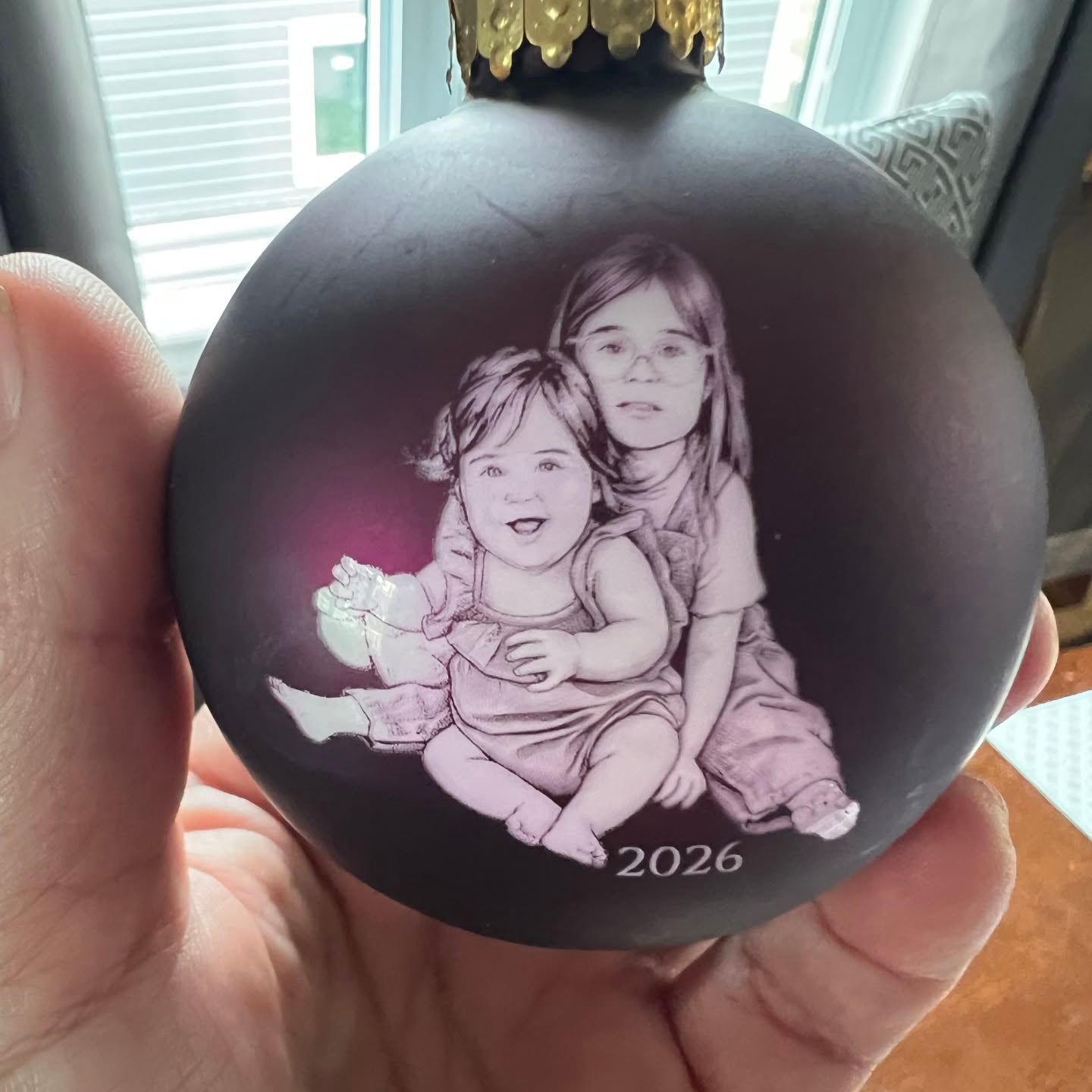 Personalized glass Christmas ornament laser engraved with a family photo and year