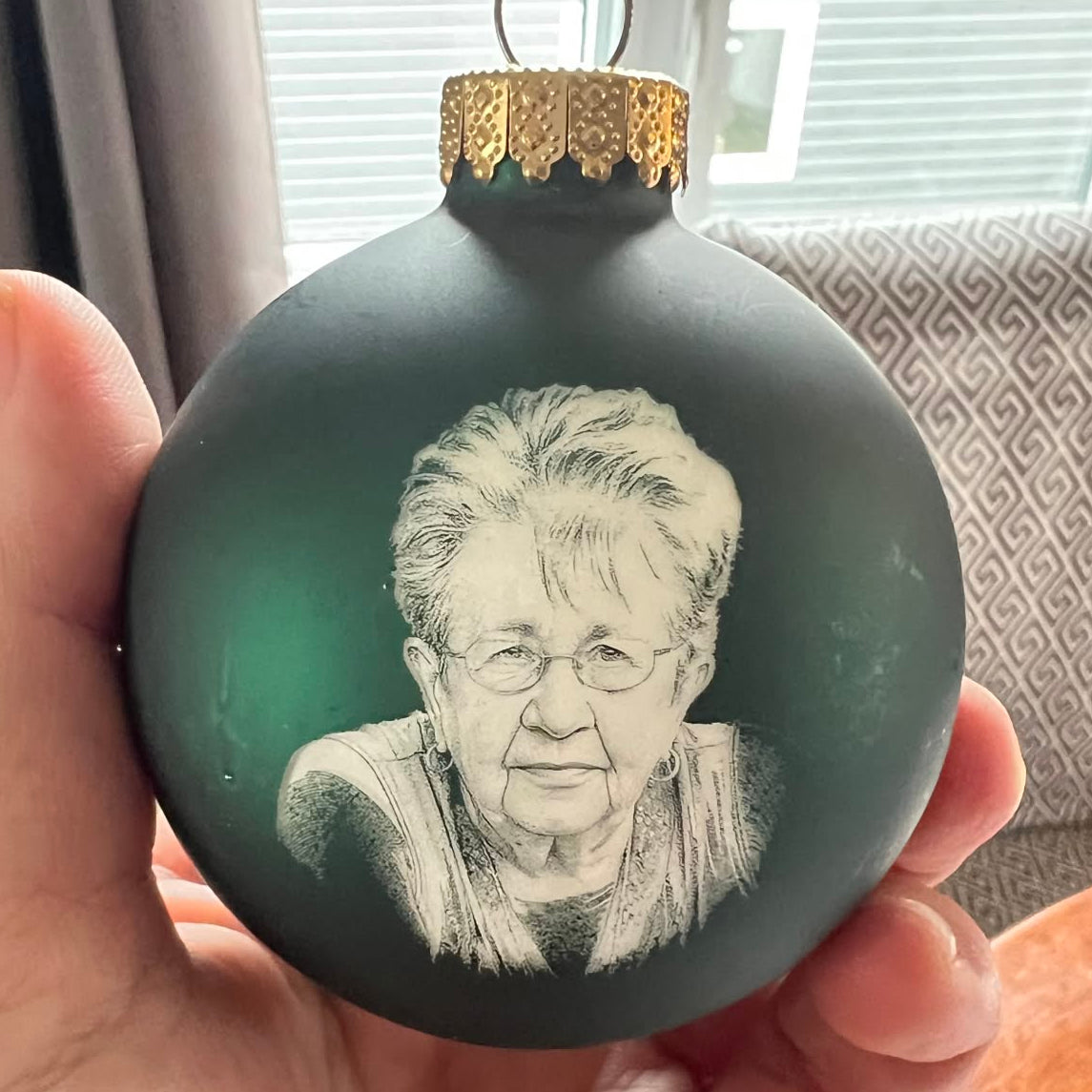Personalized glass Christmas ornament engraved with a cherished portrait photo