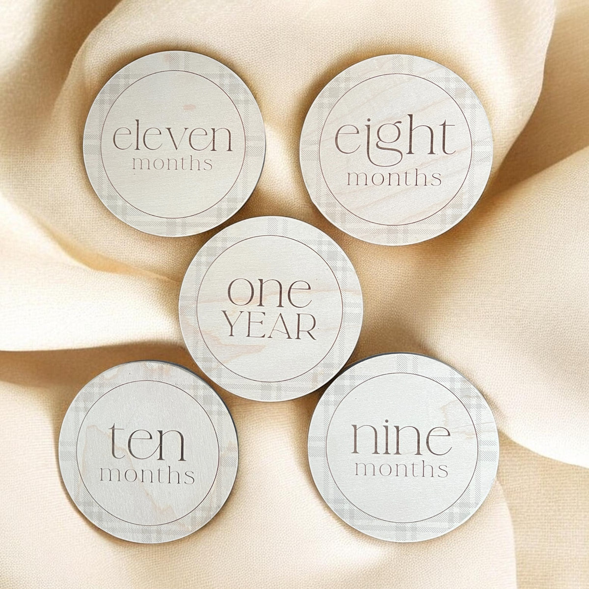 Wooden baby milestone markers for nine, ten and eleven months with One Year milestone disc